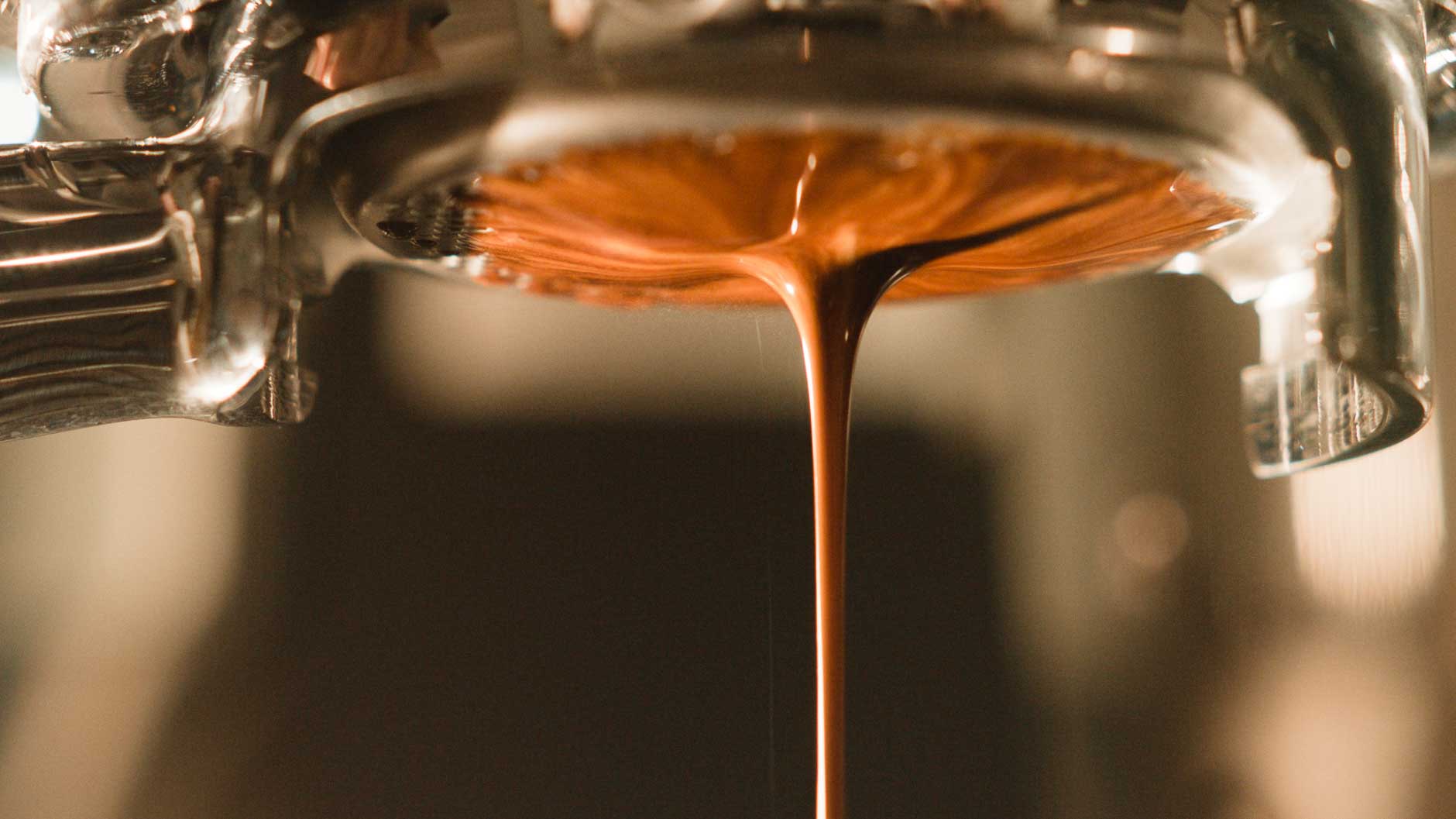 shot being brewed on a bottomless portafilter